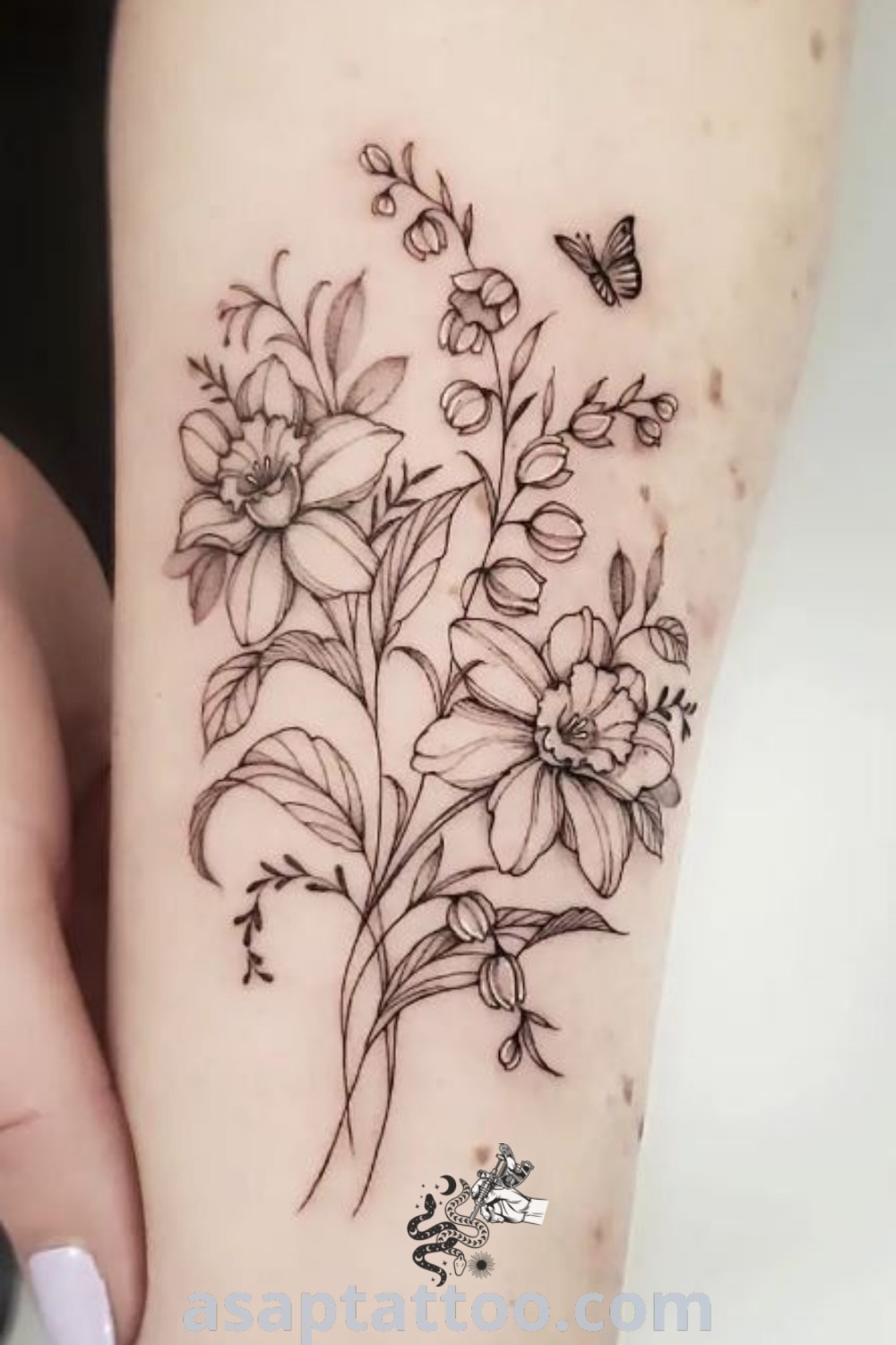 Elegant Narcissus and butterfly tattoo on a woman