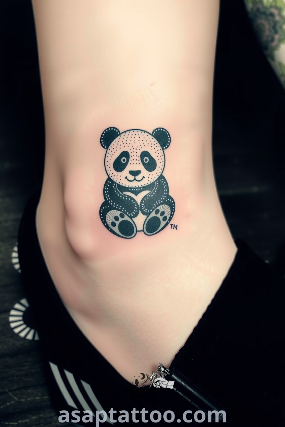 Dotwork panda tattoo on the ankle featuring intricate patterns and depth with a playful expression, a gorgeous tattoo idea you must see to believe. asaptattoo.com