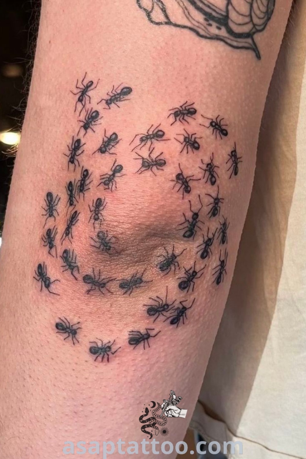 Surreal tattoo of a person with an ant tattoo on his arm covered in bugs, showcasing a blend of powerful creatures and funky designs. Explore creative tattoo inspiration at asaptattoo.com.