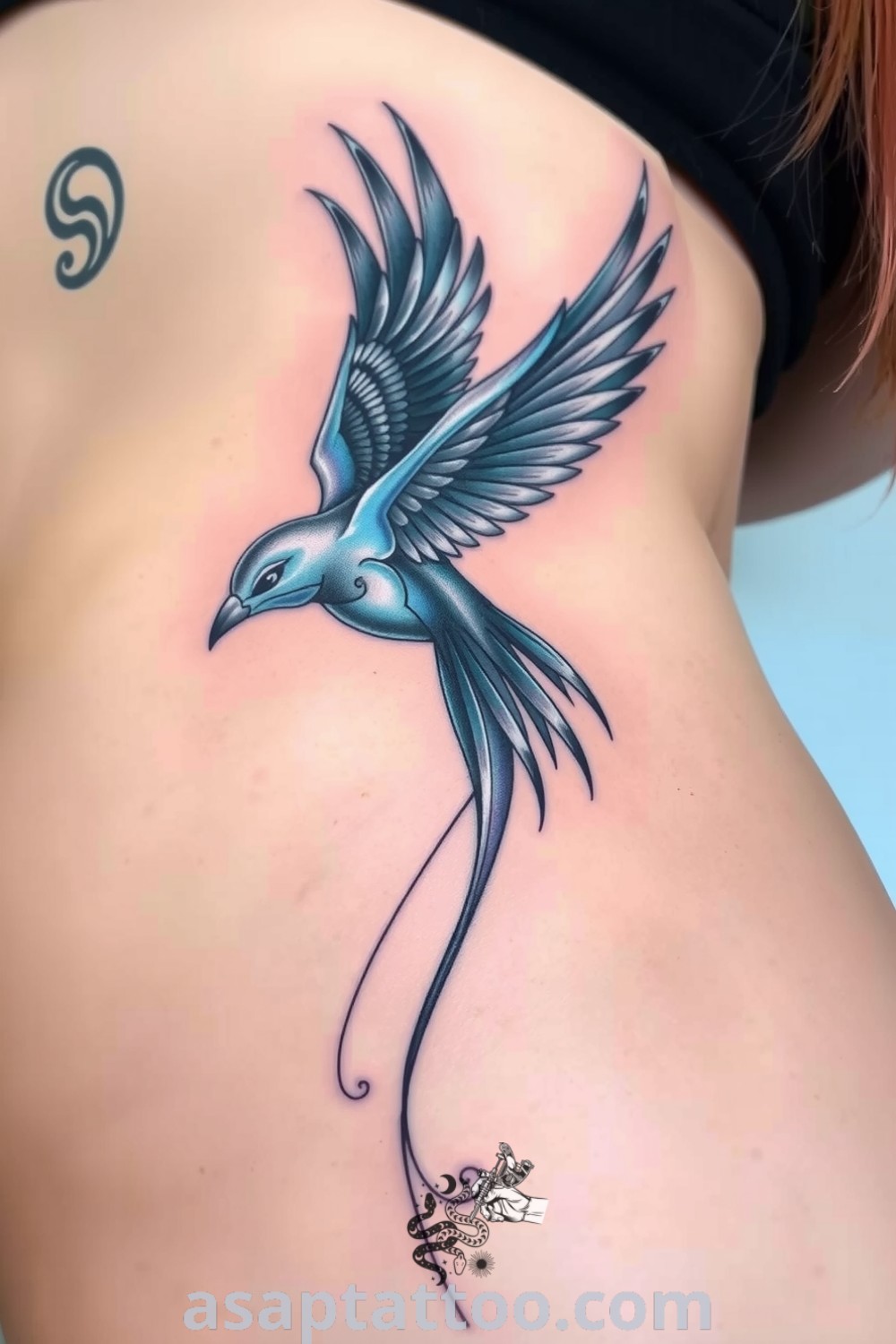Futuristic bird tattoo with intricate linework and a blend of blues and silvers, symbolizing freedom and aspiration. An elegant tattoo idea you must see to believe. asaptattoo.com
