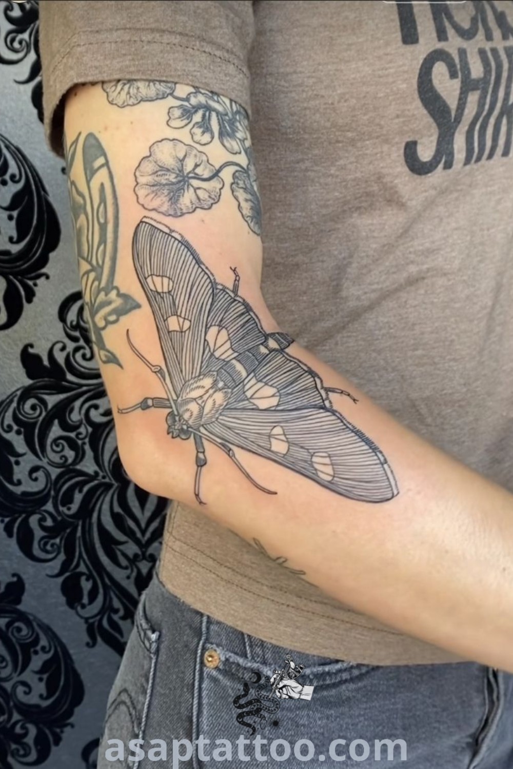 Stunning moth arm tattoo showcasing artistic details and earthy tones. An inspiring aesthetic for those seeking bug and insect tattoos. Discover more amazing tattoo ideas at asaptattoo.com.