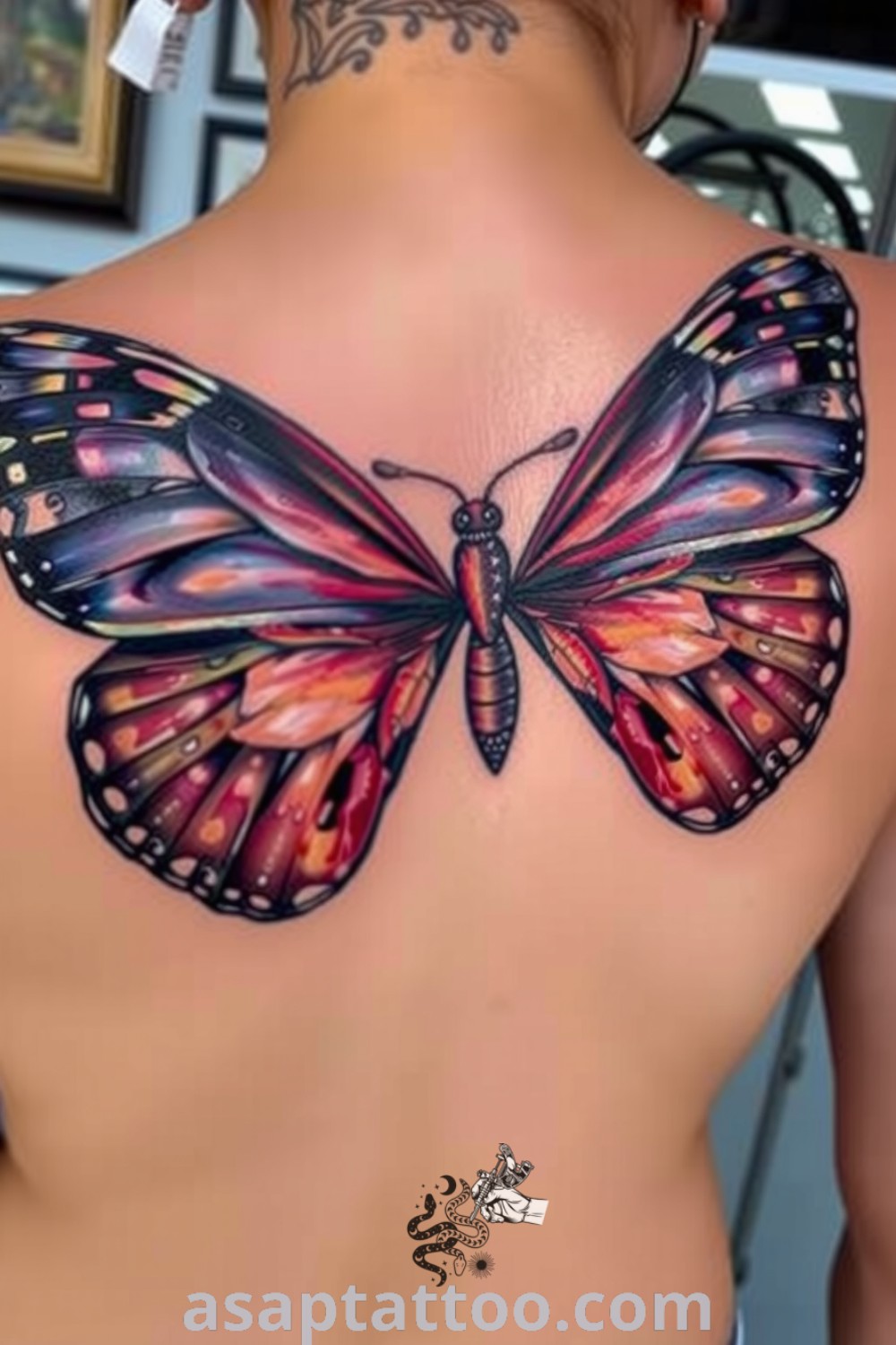 Realistic butterfly tattoo on upper back featuring intricate wings in deep blue and rich orange, symbolizing freedom and transformation. An amazing tattoo idea you must see. asaptattoo.com