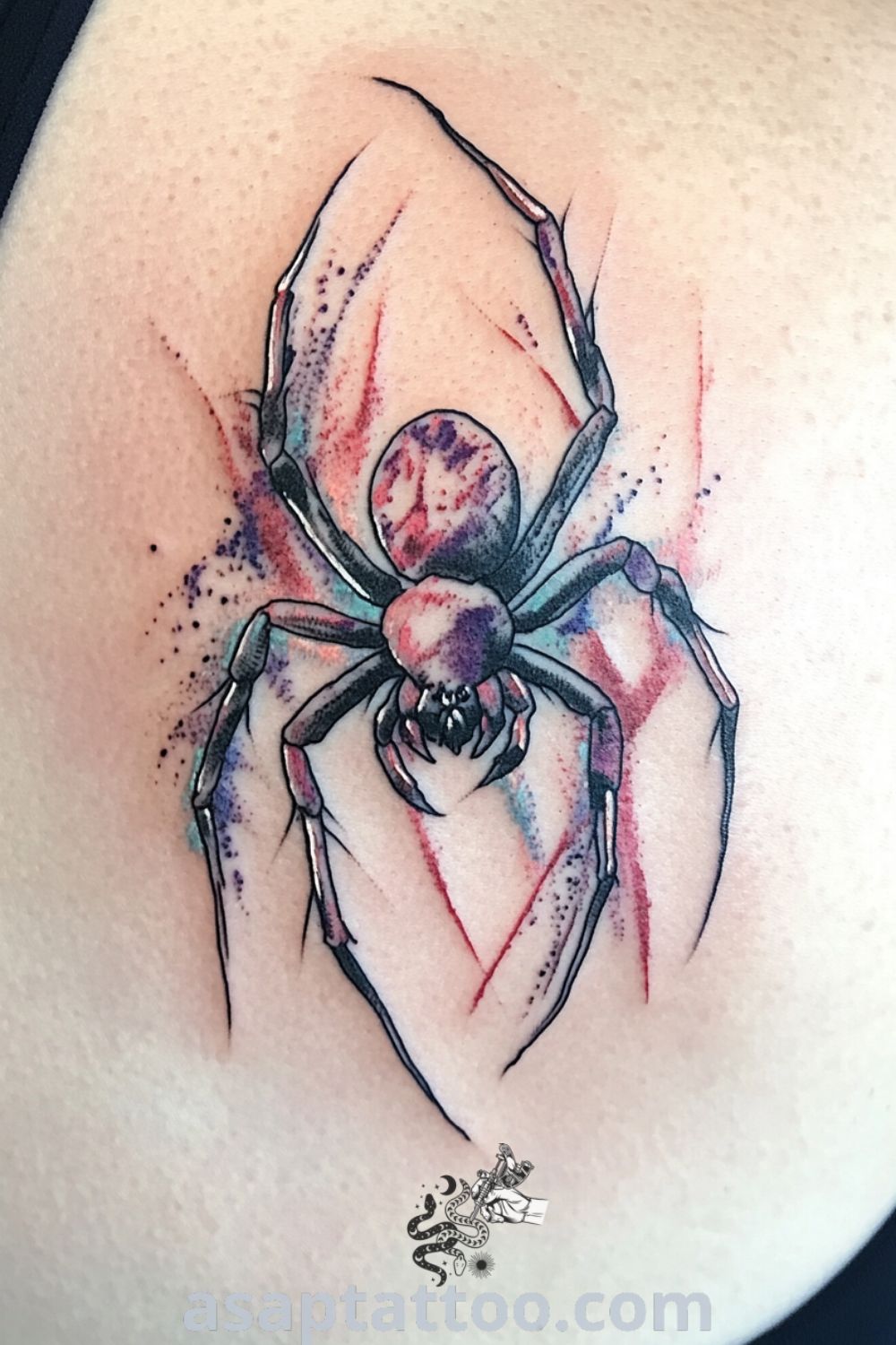 Watercolor spider tattoo with deep red, blue, and black hues creating soft gradients and delicate linework. A gorgeous tattoo idea that will inspire you to get inked. asaptattoo.com