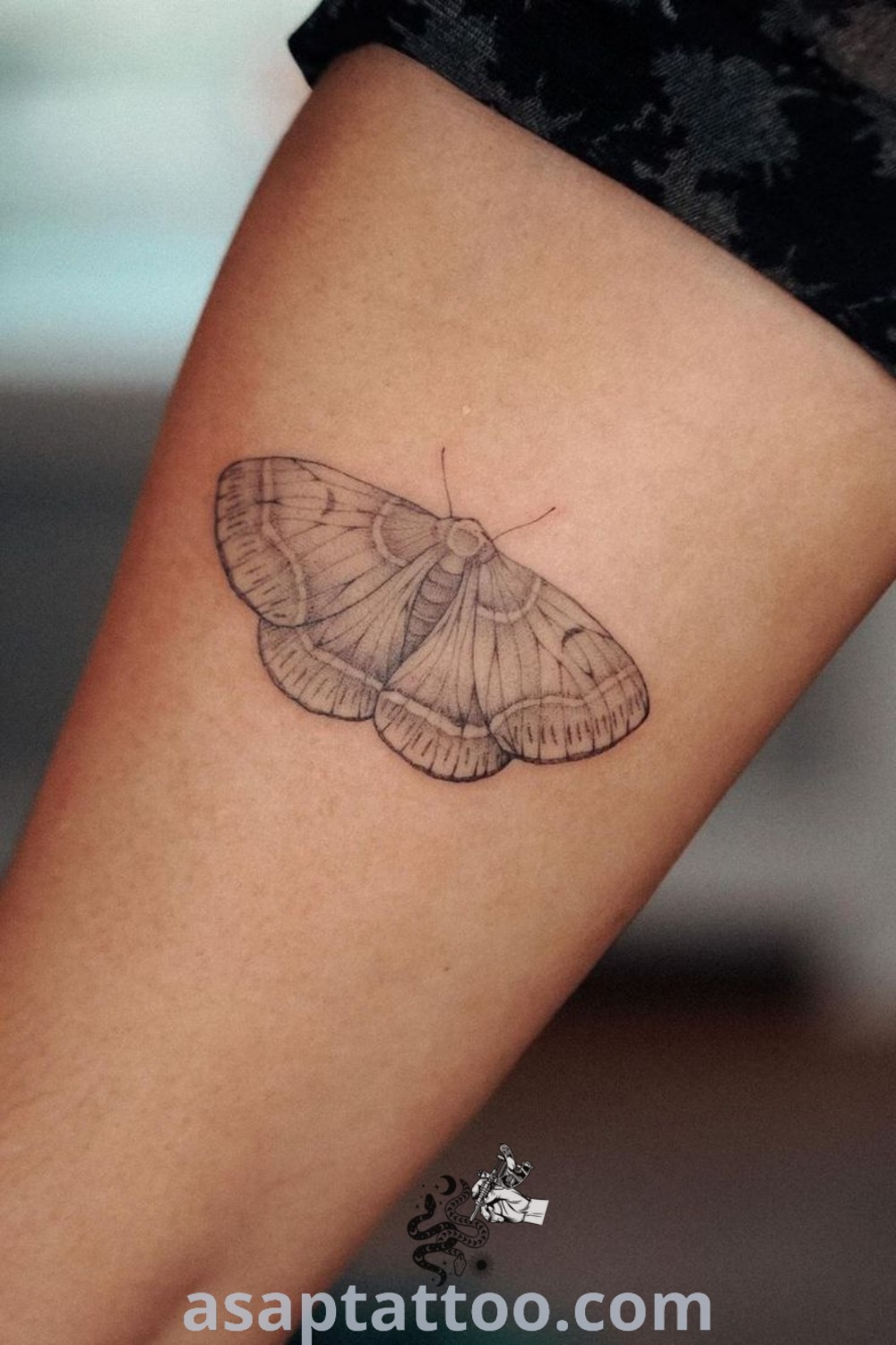Small moth tattoo on the right thigh and upper leg, featuring elegant fineline design. A perfect choice for women seeking inspiring and cute moth tattoos. Explore more amazing tattoo ideas at asaptattoo.com.