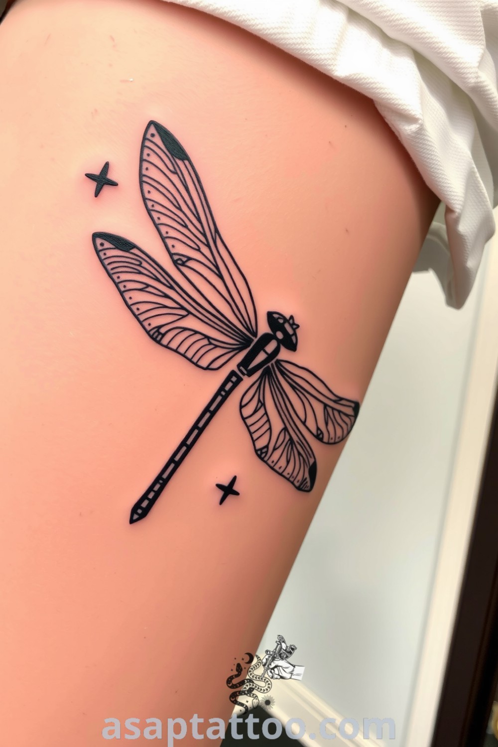 Blackwork dragonfly tattoo with intricate linework and bold geometric patterns, showcasing depth and elegance. A gorgeous tattoo idea that symbolizes transformation and harmony you must see. asaptattoo.com