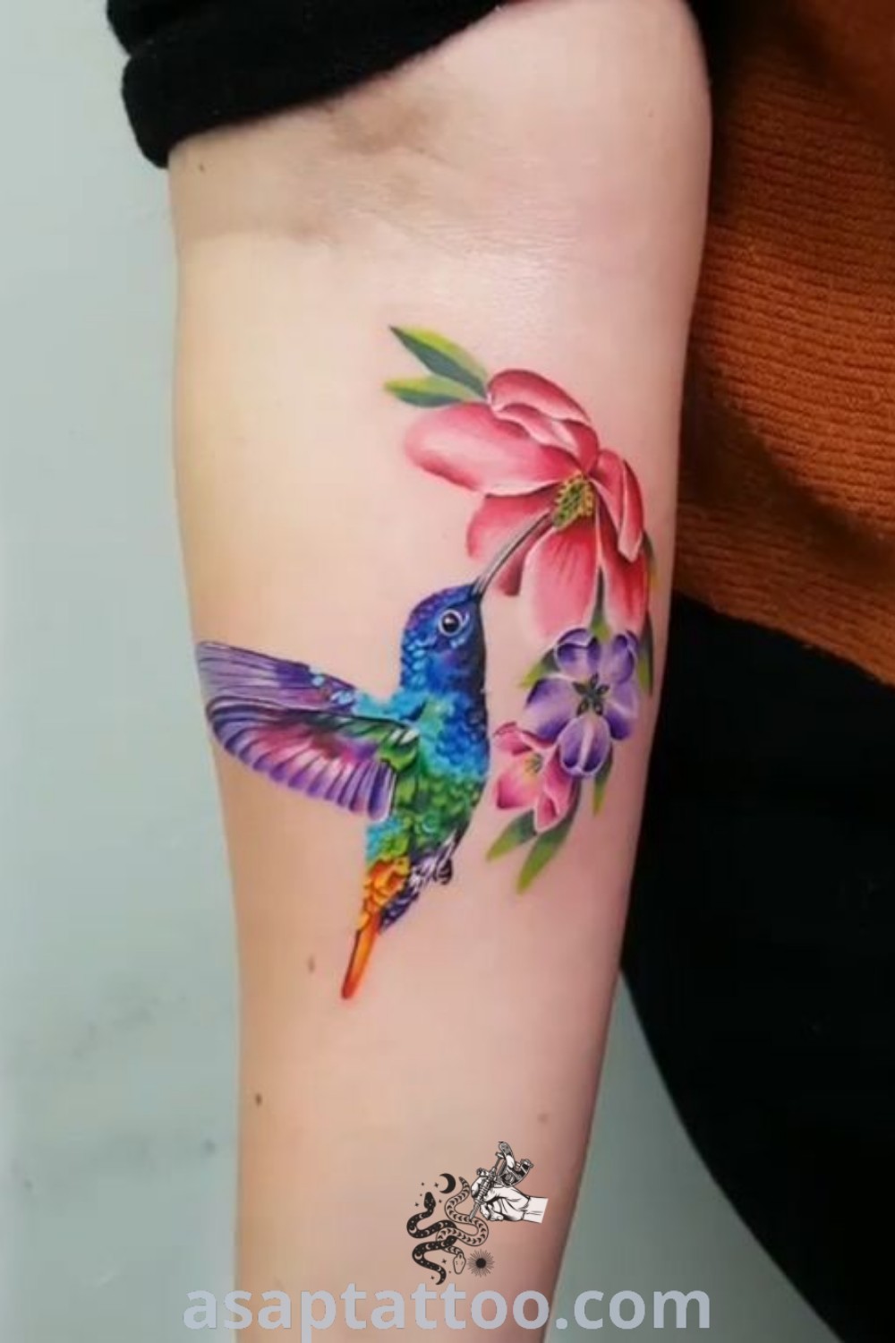 Colorful hummingbird and butterfly tattoo featuring floral designs. An inspiring choice for women seeking watercolor tattoos that will melt your heart. Explore more at asaptattoo.com.