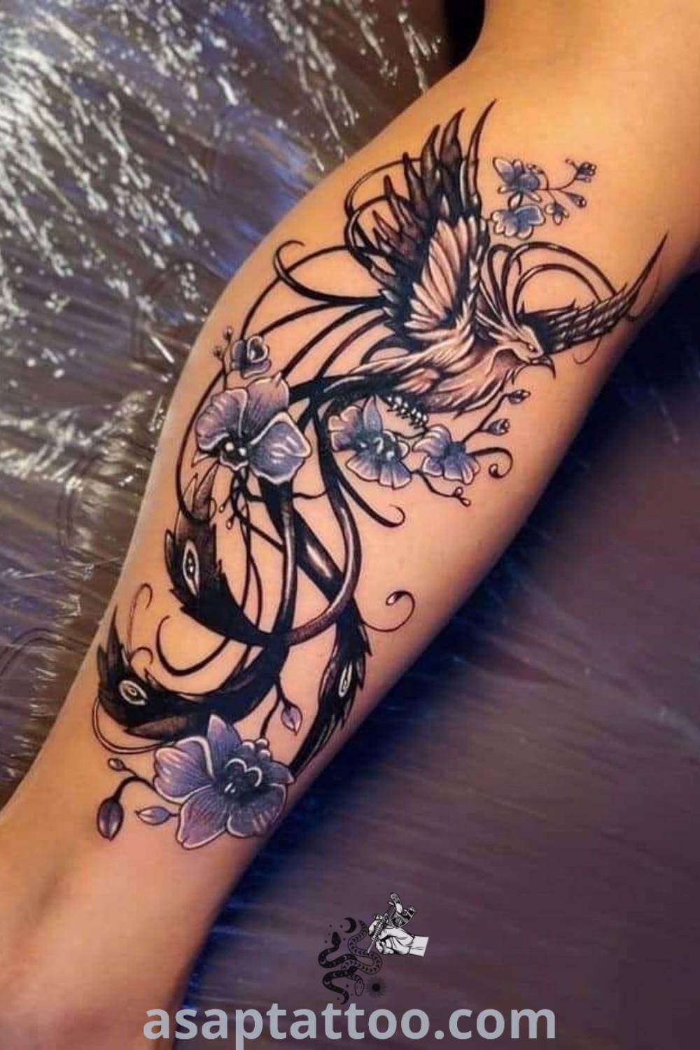 Elegant Phoenix tattoo sleeve featuring intricate designs of small phoenix and flower tattoos. A must-see for those seeking inspiring body art. Explore more ideas at asaptattoo.com.