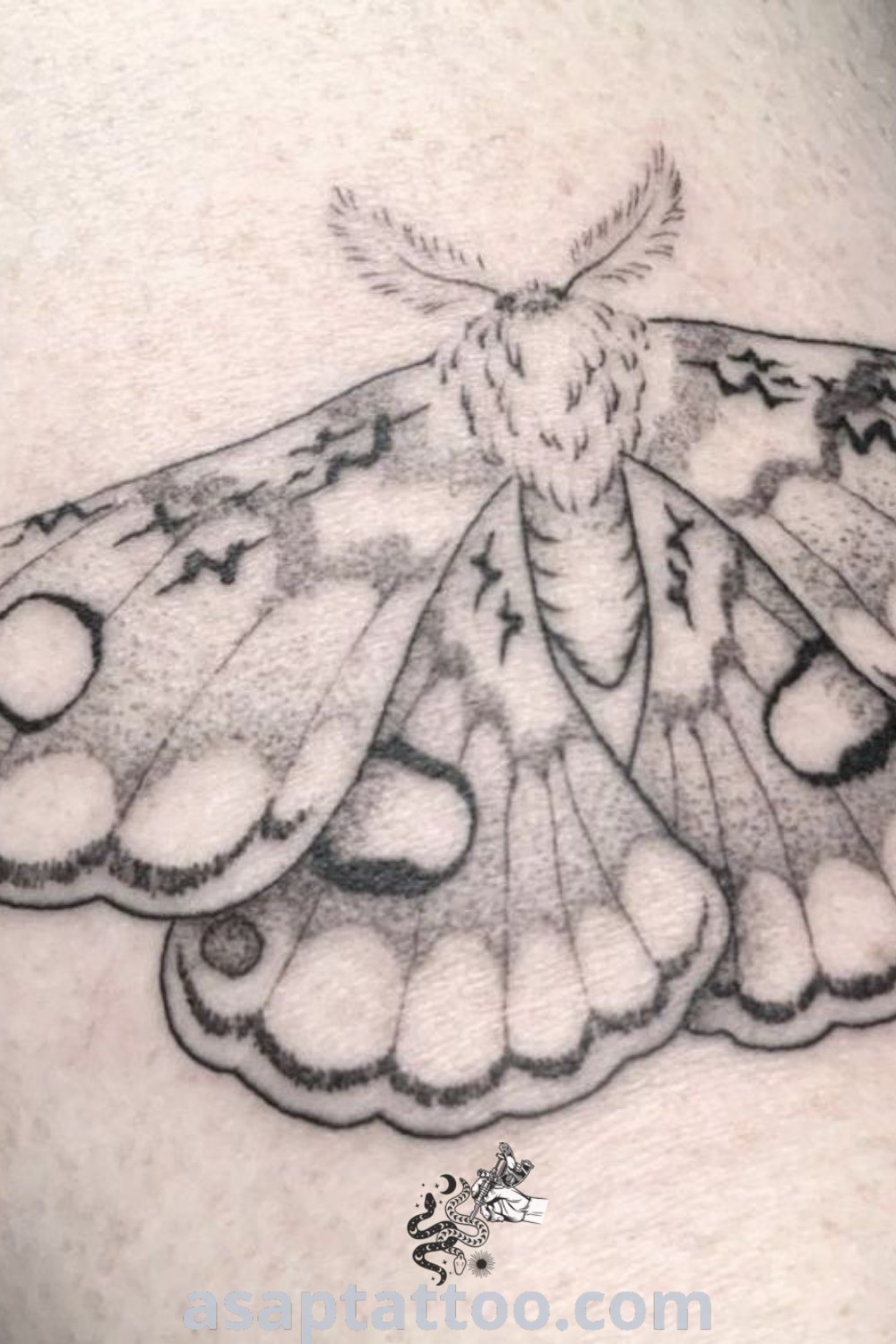 Black and white moth tattoo on the leg featuring elegant dot work design. A gorgeous inspiration for tattoo lovers seeking unique moth tattoo ideas. Discover more at asaptattoo.com.