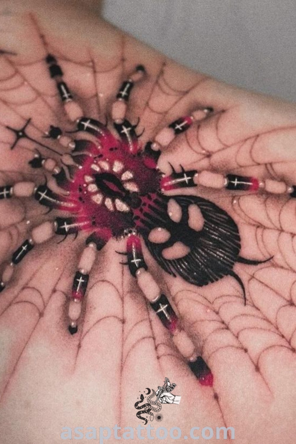 A beautiful spider web tattoo in black and pink on a woman