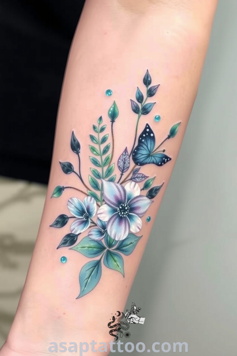 Watercolor plant tattoo with shades of blue, green, and lavender creating a dreamlike effect on the forearm, featuring delicate leaves and petals. An elegant tattoo idea you must see to believe. asaptattoo.com
