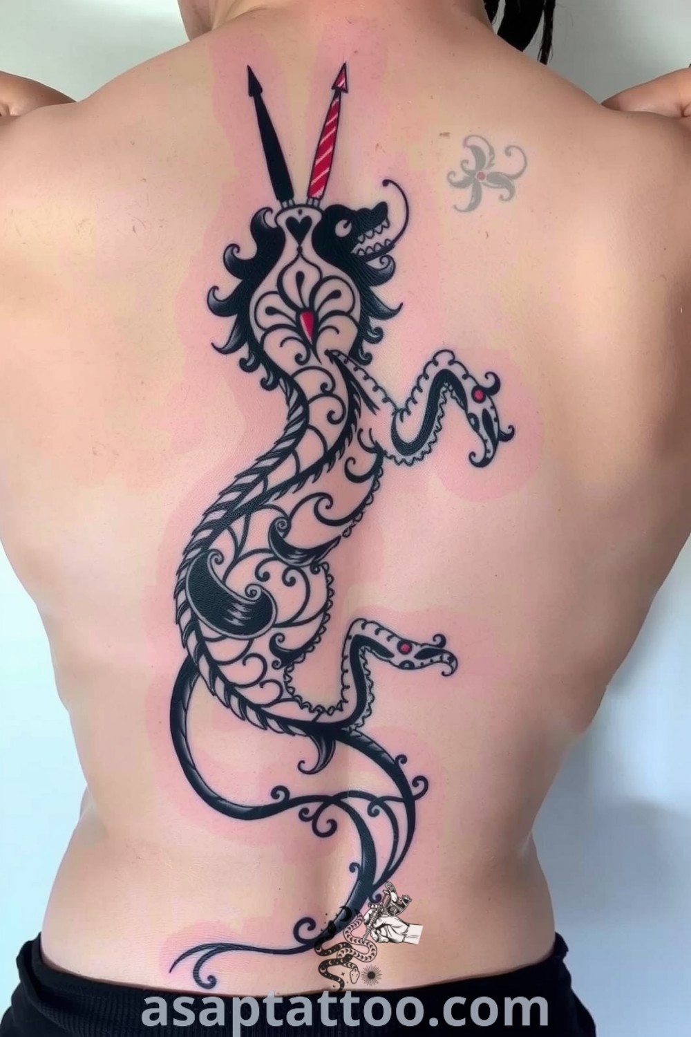 Intricate spine tattoo of a mythical creature, beautifully detailed with flowing patterns and delicate shading. This elegant tattoo with meaning is a gorgeous design you will absolutely love. asaptattoo.com