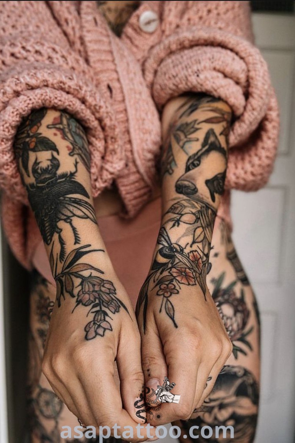 A woman with captivating black tattoos with a pop of color on her arms and hands, showcasing an eclectic sleeve tattoo aesthetic. This artistic design features moody floral elements and symbolizes personal expression. Discover more amazing tattoo ideas at asaptattoo.com.