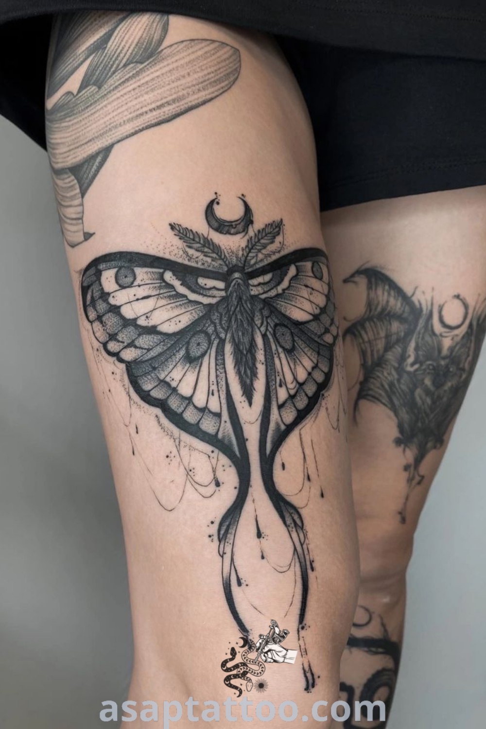 A woman’s legs showcasing tattoos with a butterfly design on the front thigh, representing gorgeous tattoo ideas perfect for inspiration. Discover amazing leg tattoos that will inspire you to get inked at asaptattoo.com.