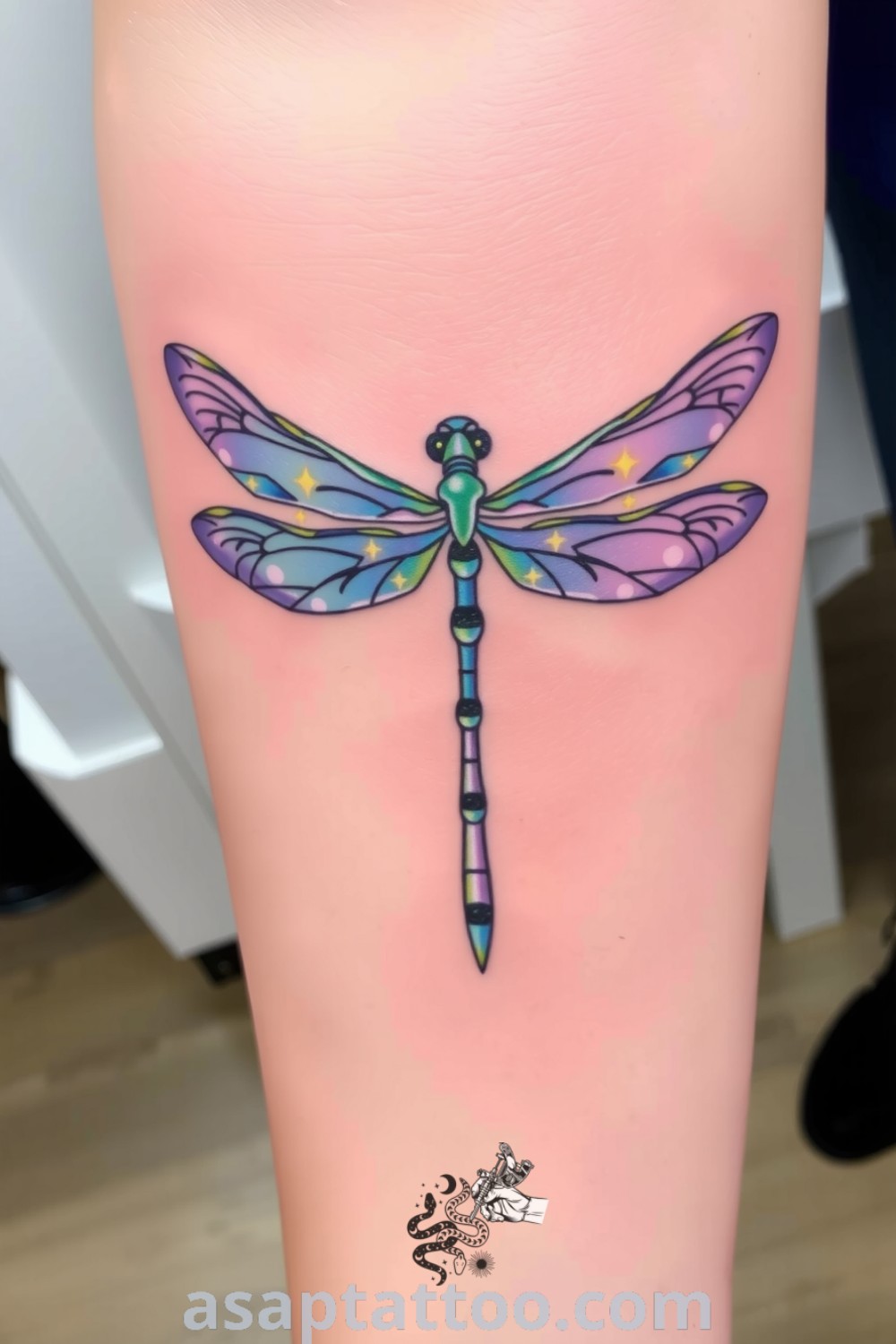 Celestial dragonfly tattoo with intricate linework, blending deep blues and ethereal purples, symbolizing transformation and hope. An inspiring and gorgeous tattoo idea you must see. asaptattoo.com