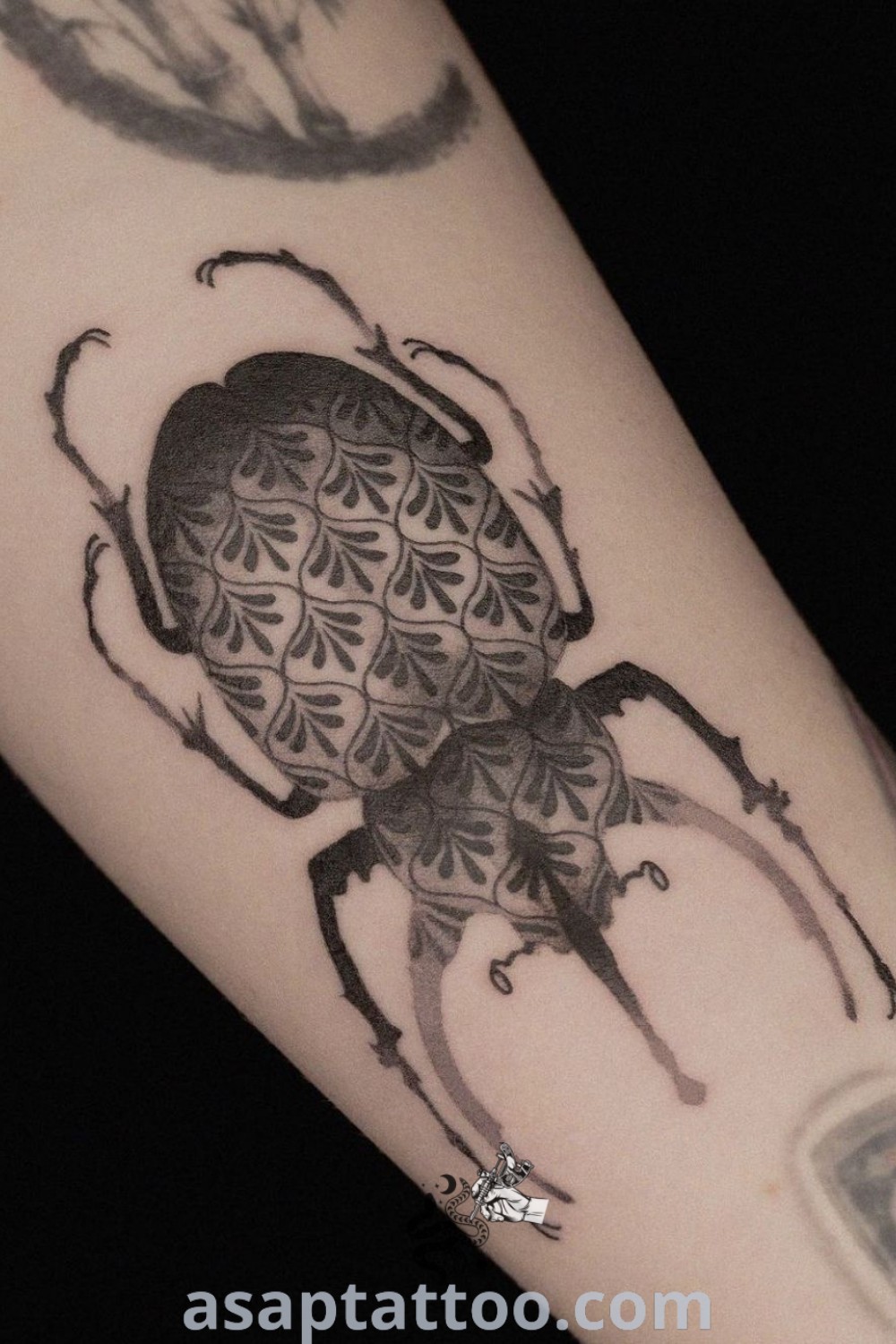 Stunning Atlas Beetle tattoo on the arm, showcasing intricate red ink details and elegant design. An inspiring choice for modern tattoos that will absolutely melt your heart. Discover the best tattoo ideas at asaptattoo.com.