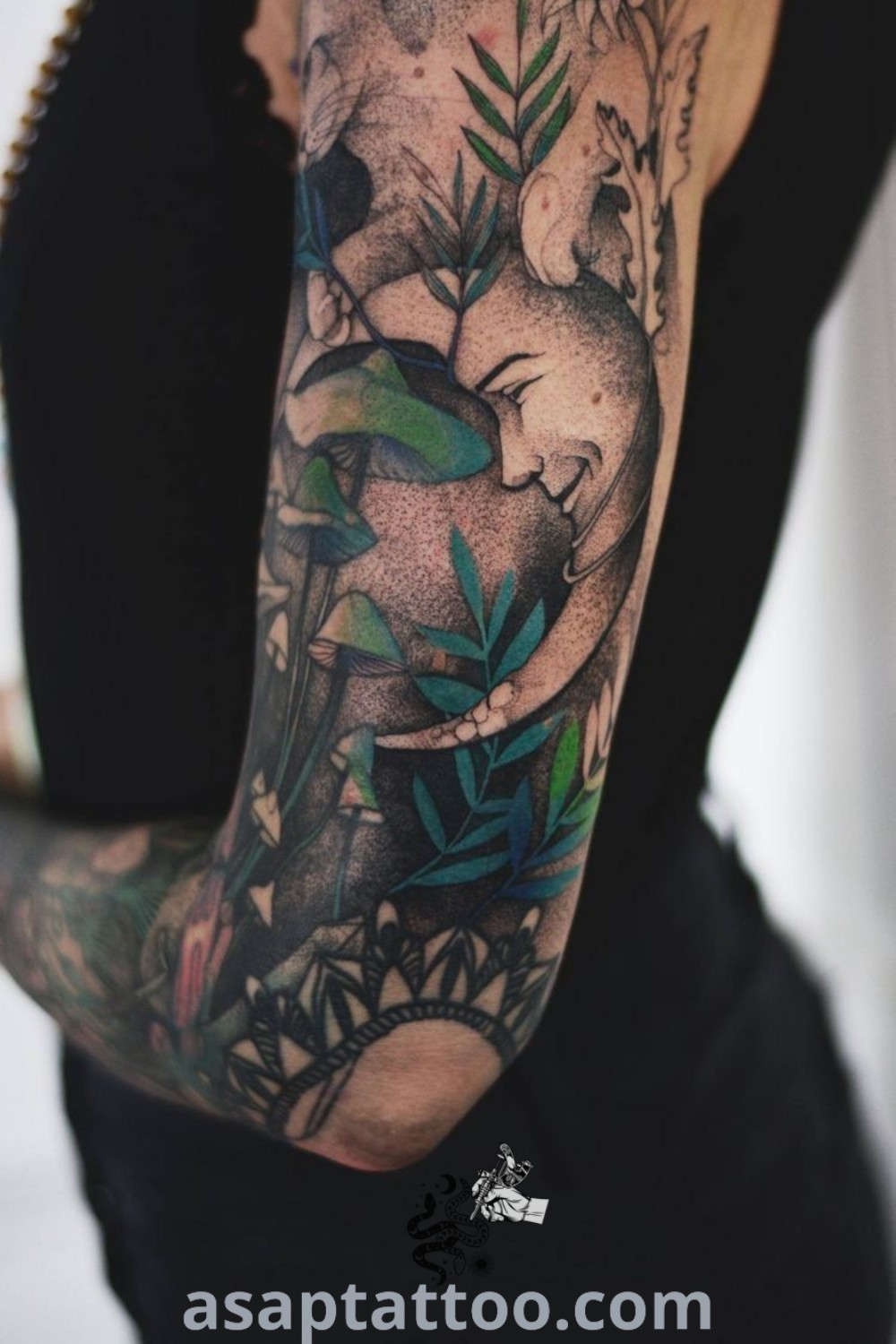 A woman with tattoos on her arm holding an elephant and leaves, showcasing amazing tattoo art including mushroom tattoos and shape tattoos. For more best tattoo ideas that will inspire you to get inked, visit asaptattoo.com.