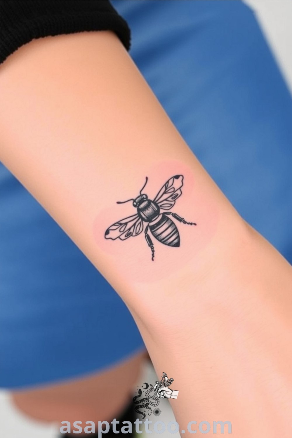Minimalist bee tattoo on wrist with fine linework and subtle shading for depth, symbolizing hard work and community. An elegant tattoo idea that you must see to believe. asaptattoo.com