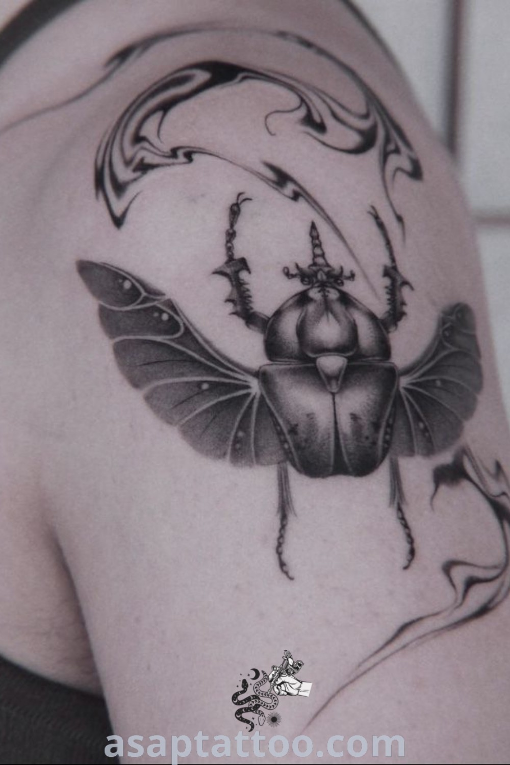 Black and white beetle tattoo on a woman