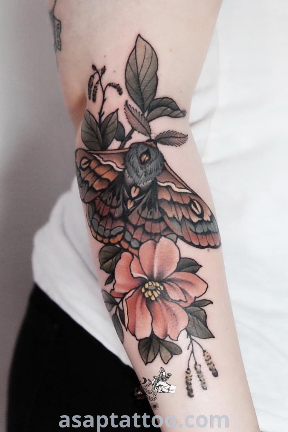 Close-up of a person with a neoamerican traditional tattoo of a moth on their arm, part of a floral sleeve design, showcasing artistic features. Discover unique women