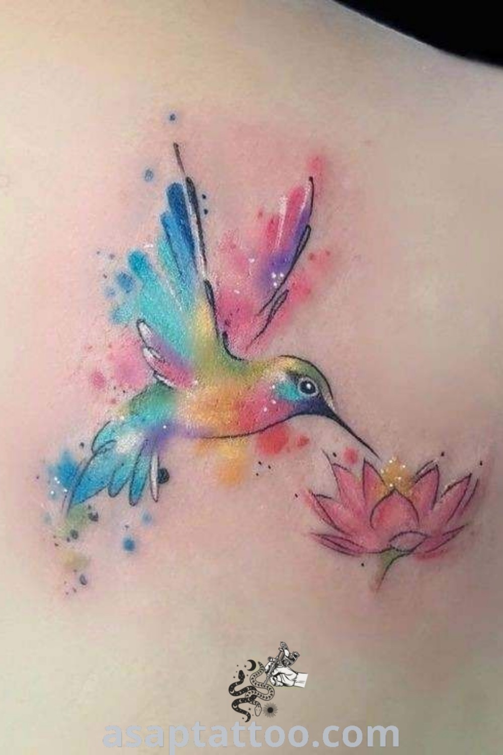 Watercolor hummingbird tattoo on the back of a woman