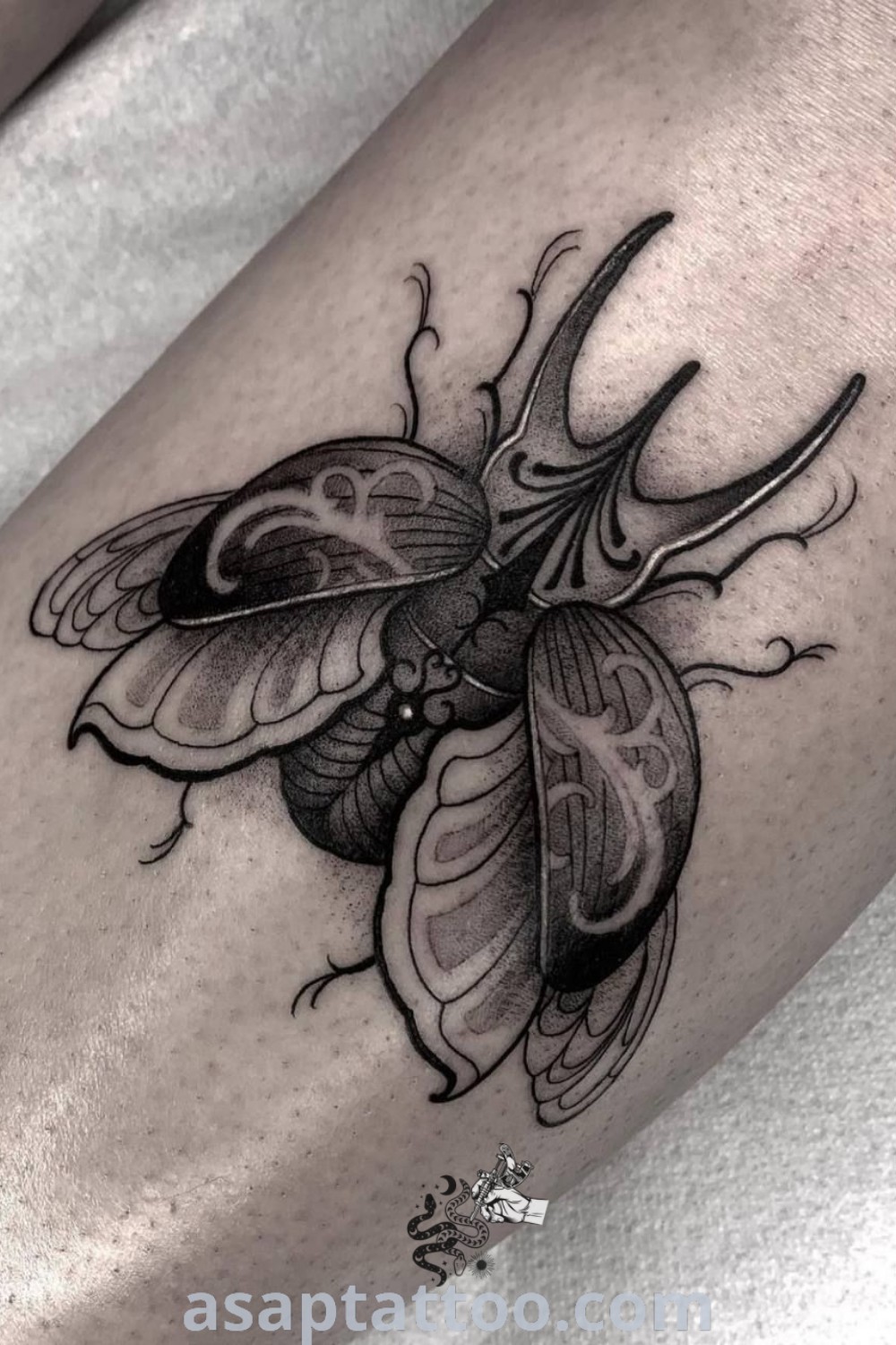 Elegant June Bug tattoo on a woman