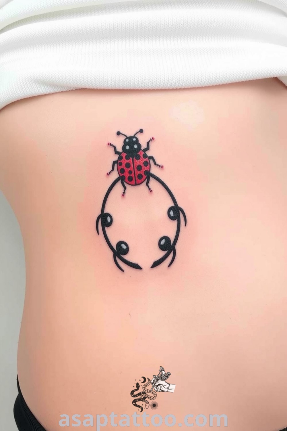 Dotwork ladybug tattoo on ribcage showcasing intricate patterns in black and deep red, symbolizing good luck and protection. A gorgeous tattoo idea you must see to believe. asaptattoo.com