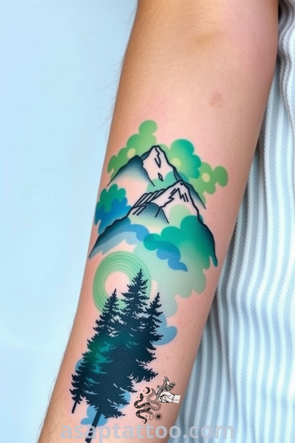 Watercolor tattoo of mountains and forests with deep greens and blues, highlighted by intricate linework and soft pastels. A gorgeous tattoo idea that will inspire you to get inked. asaptattoo.com