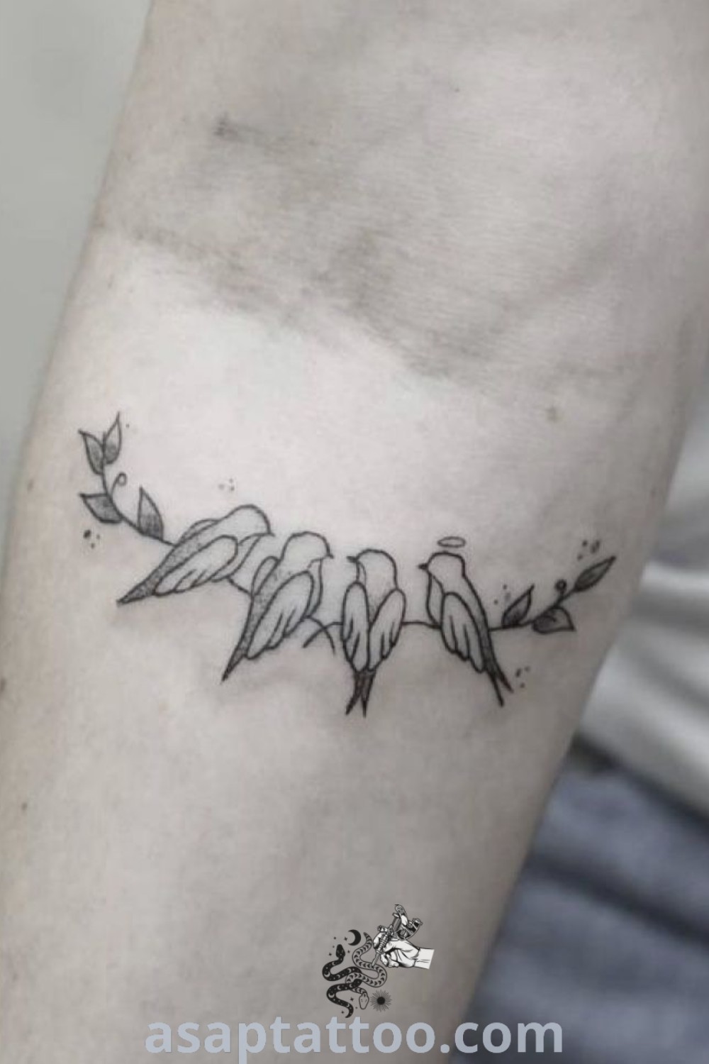 Tattoo on the arm of a man featuring three birds and an arrow, showcasing an elegant design with meaning. Ideal for those seeking gorgeous tattoos to inspire their next ink. Explore more at asaptattoo.com.