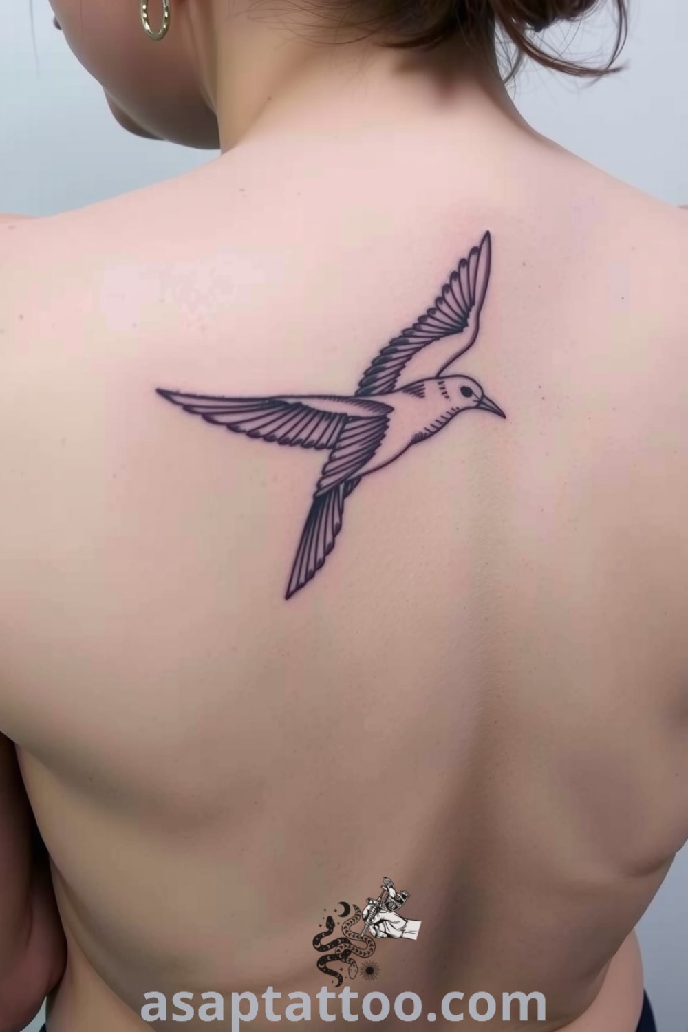 Intricate etching bird tattoo on the spine with detailed linework and shading, symbolizing freedom and aspiration. A gorgeous tattoo idea that will inspire you to get inked. asaptattoo.com