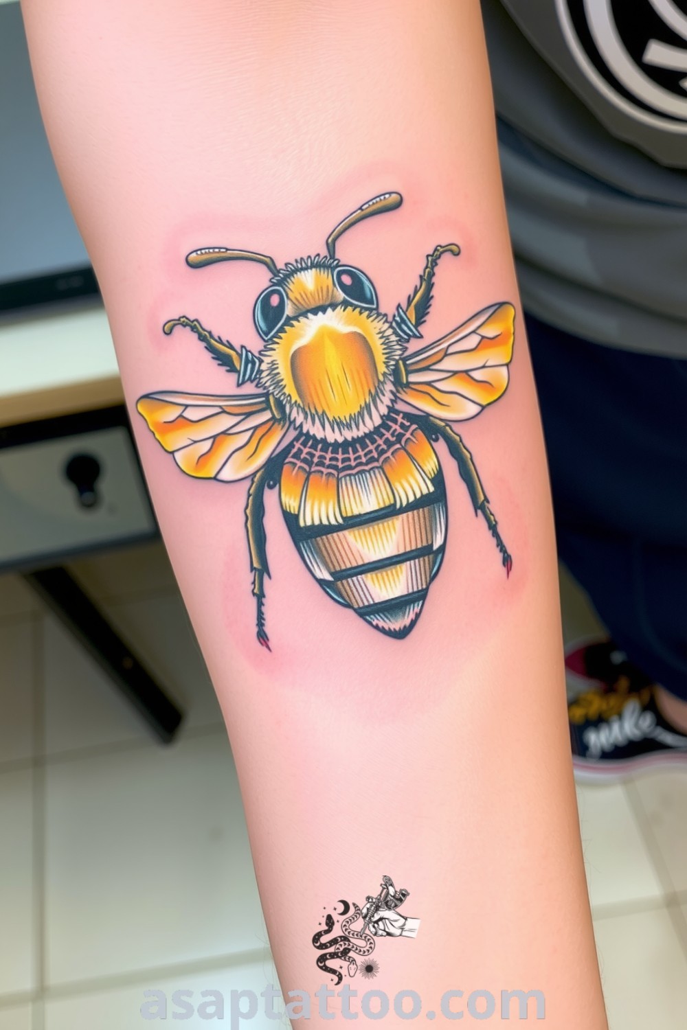 Intricate neo-traditional bee tattoo with bold black outlines and rich yellow and gold accents, showcasing a three-dimensional effect. A gorgeous tattoo idea that you must see to believe. asaptattoo.com