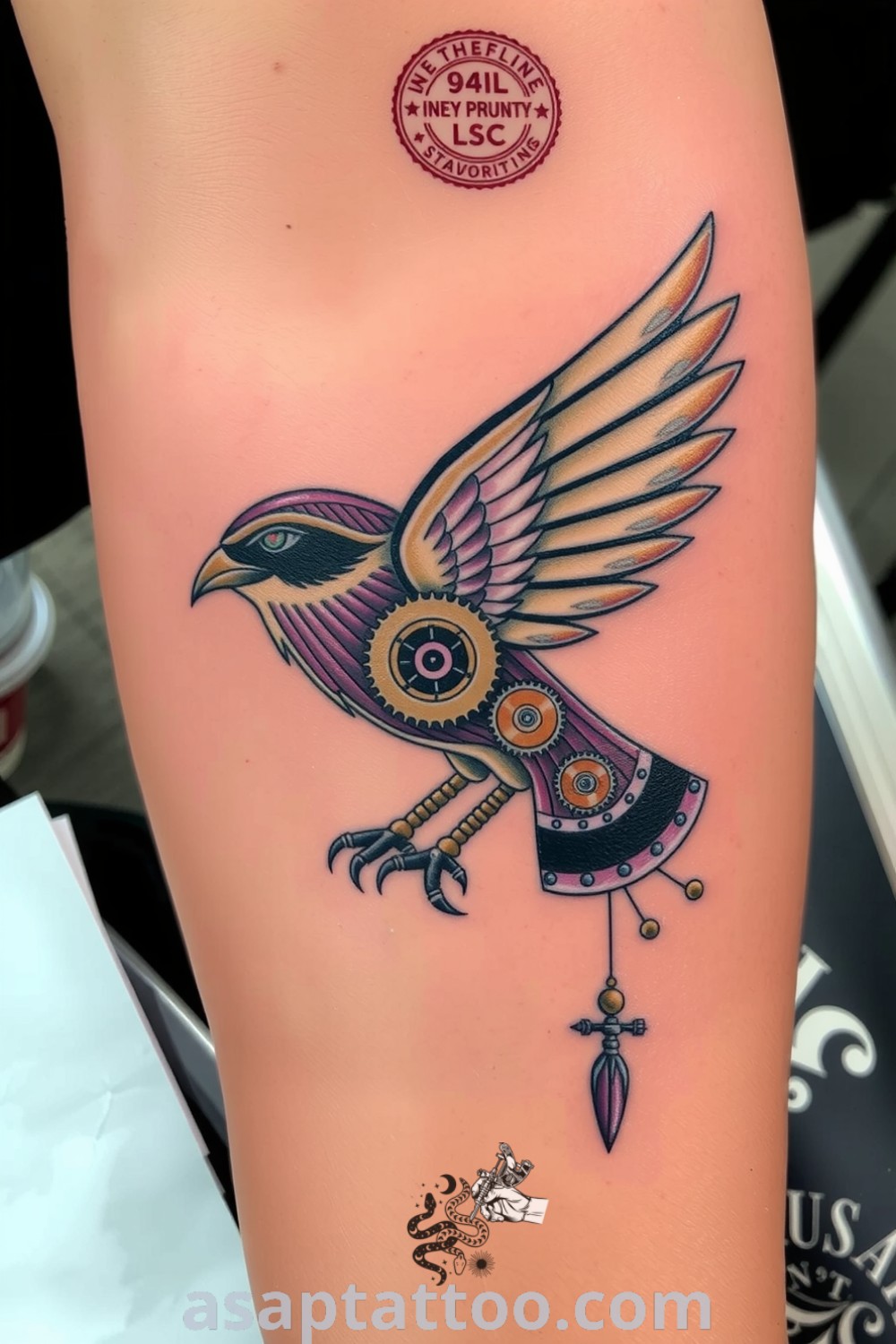 Intricate steampunk bird tattoo with gears and cogs in copper and bronze tones, symbolizing freedom and ingenuity. An amazing tattoo idea you must see to believe. asaptattoo.com