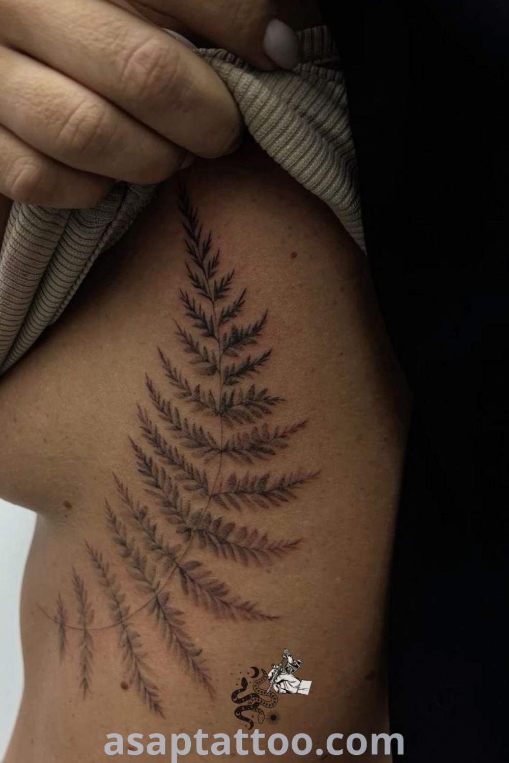 Elegant fern tattoo on a woman