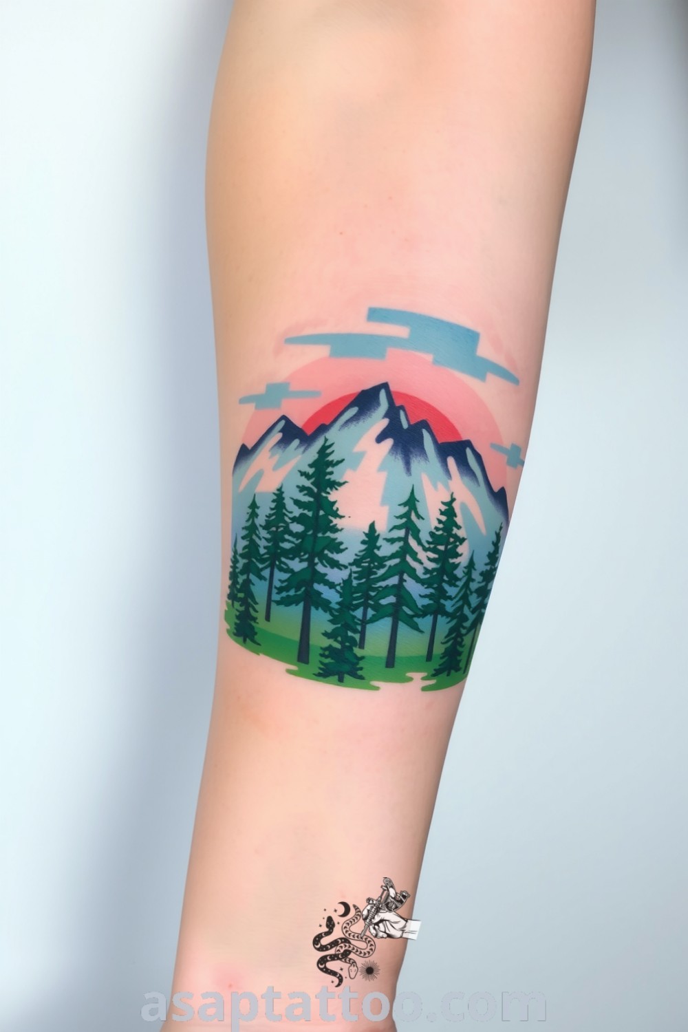Watercolor tattoo of a serene forest and majestic mountains with vibrant greens and deep blues, creating a tranquil and adventurous effect. A gorgeous tattoo idea you must see to believe. asaptattoo.com