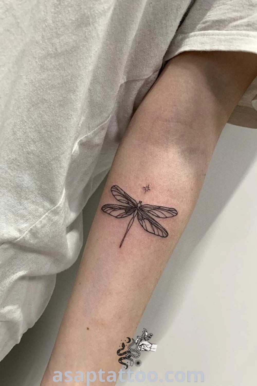 Small dragonfly tattoo on the arm showcasing a charming design that reflects the cottagecore aesthetic. This elegant artwork is perfect for anyone looking for inspiring tattoo ideas. Visit asaptattoo.com for more amazing designs.