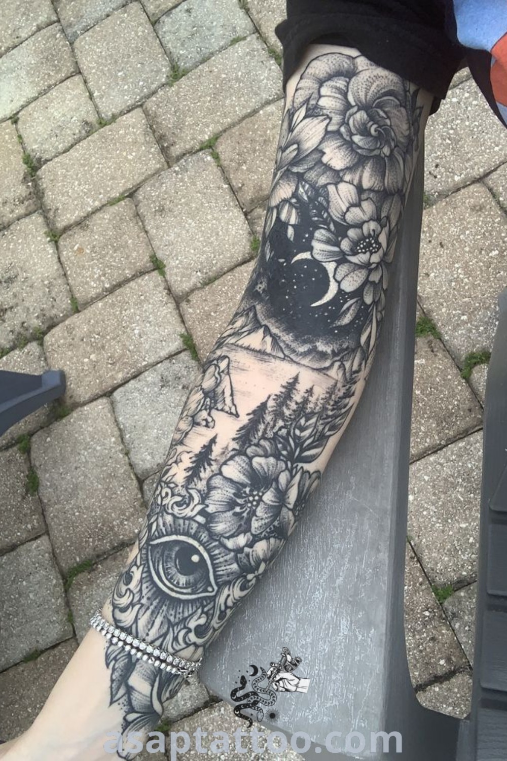 Botanical full sleeve tattoo featuring intricate floral designs on a person