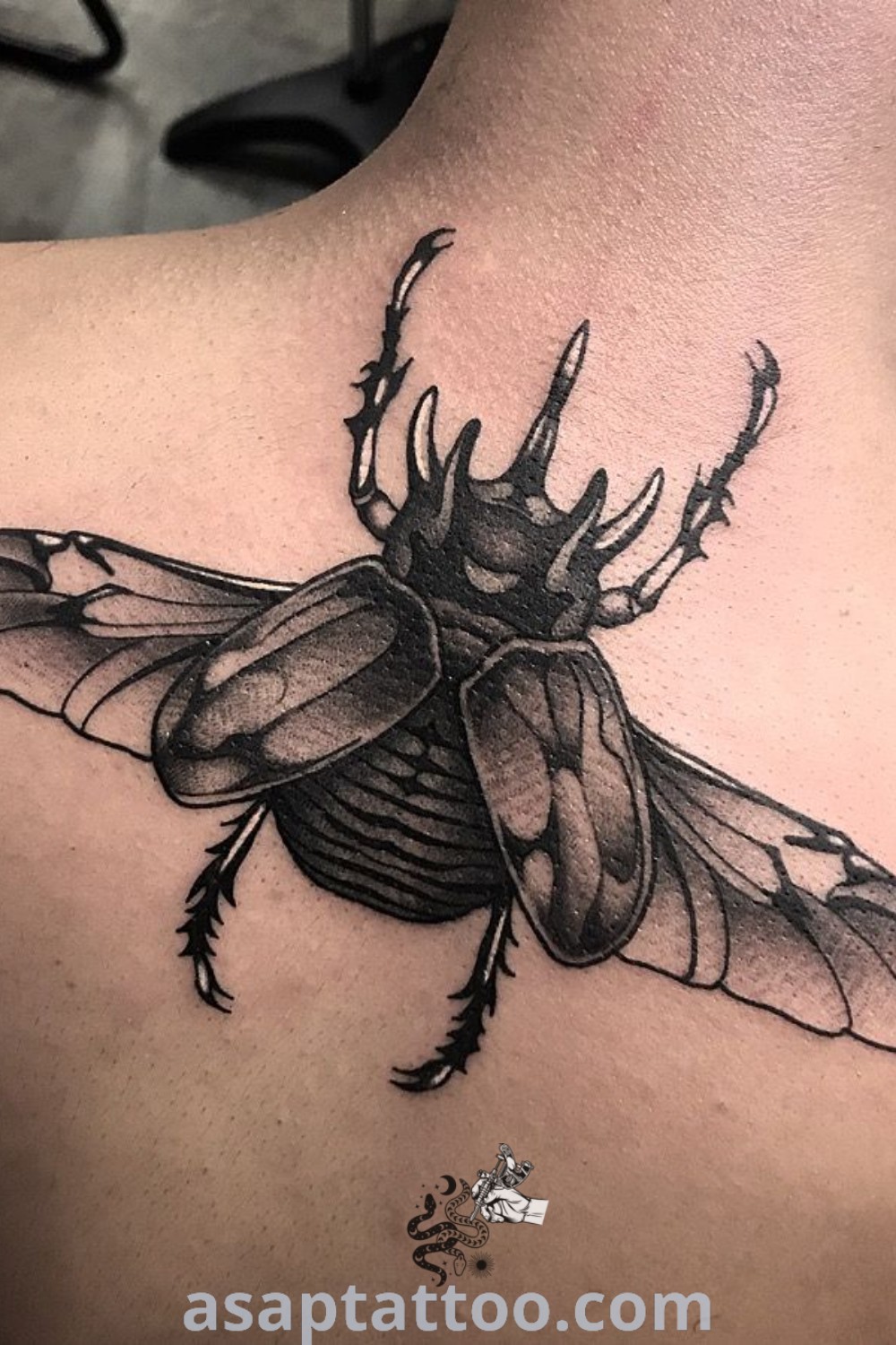 Black and white photo of a bug tattoo on a man