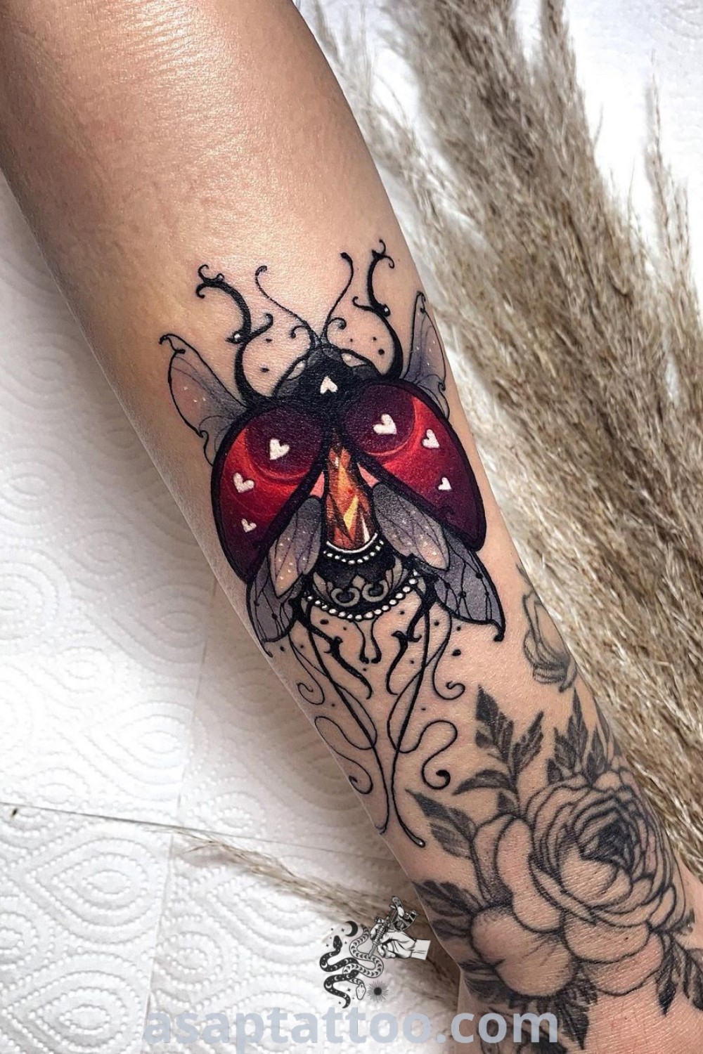 Colorful bug tattoo showcasing a ladybug and gem elements in an abstract design. An inspiring piece for tattoo lovers at asaptattoo.com.