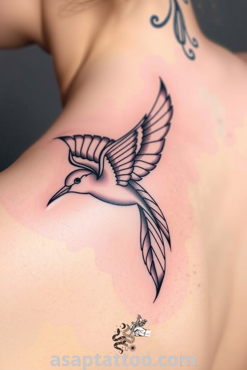 Elegant linework bird tattoo on the upper back with intricate details, showcasing depth and movement in the feathers. A gorgeous tattoo idea that will inspire you to get inked. asaptattoo.com