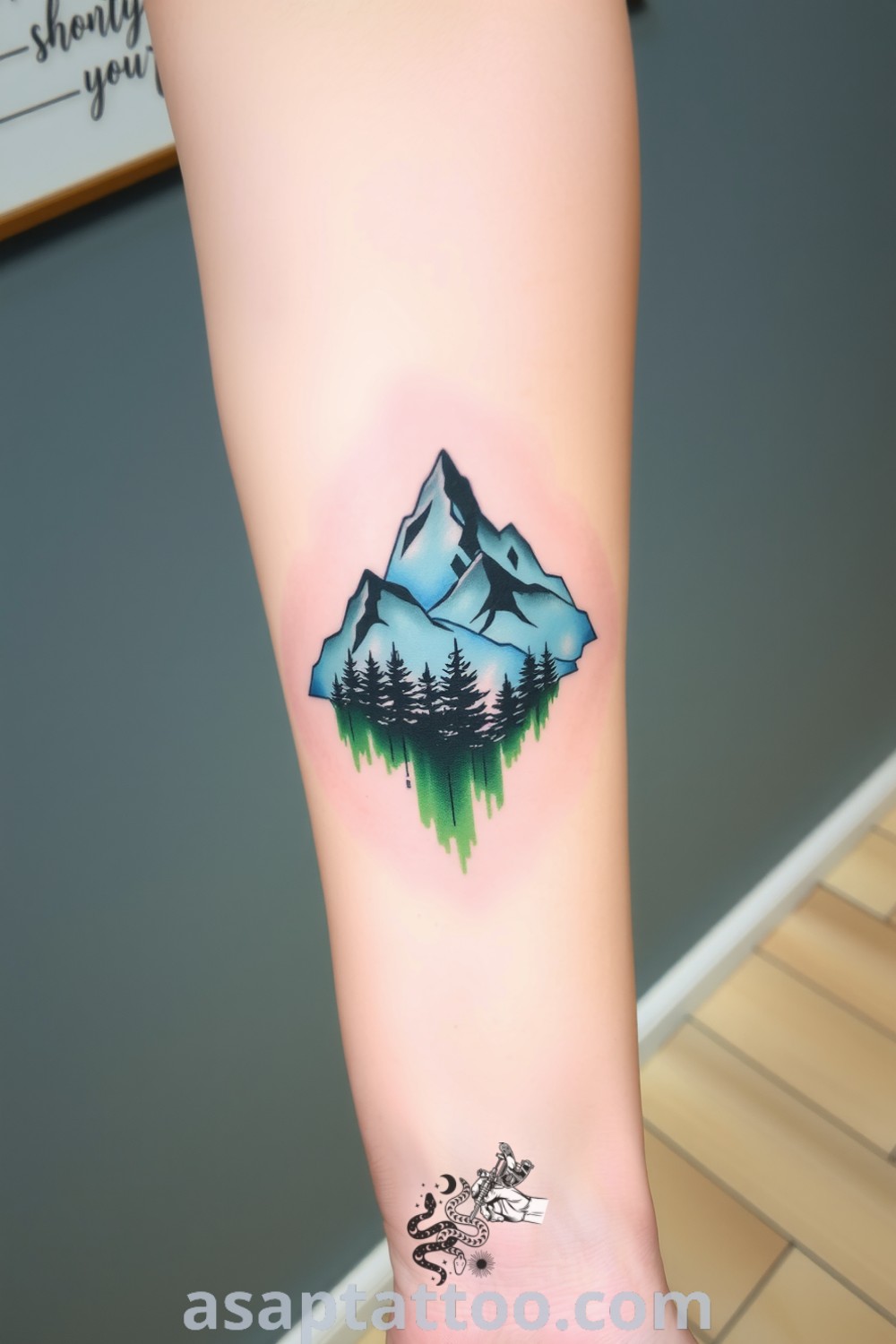 Watercolor tattoo of mountains and a forest with vivid greens and deep blues, beautifully designed with intricate linework and soft brushstrokes. An amazing tattoo idea you must see to believe. asaptattoo.com