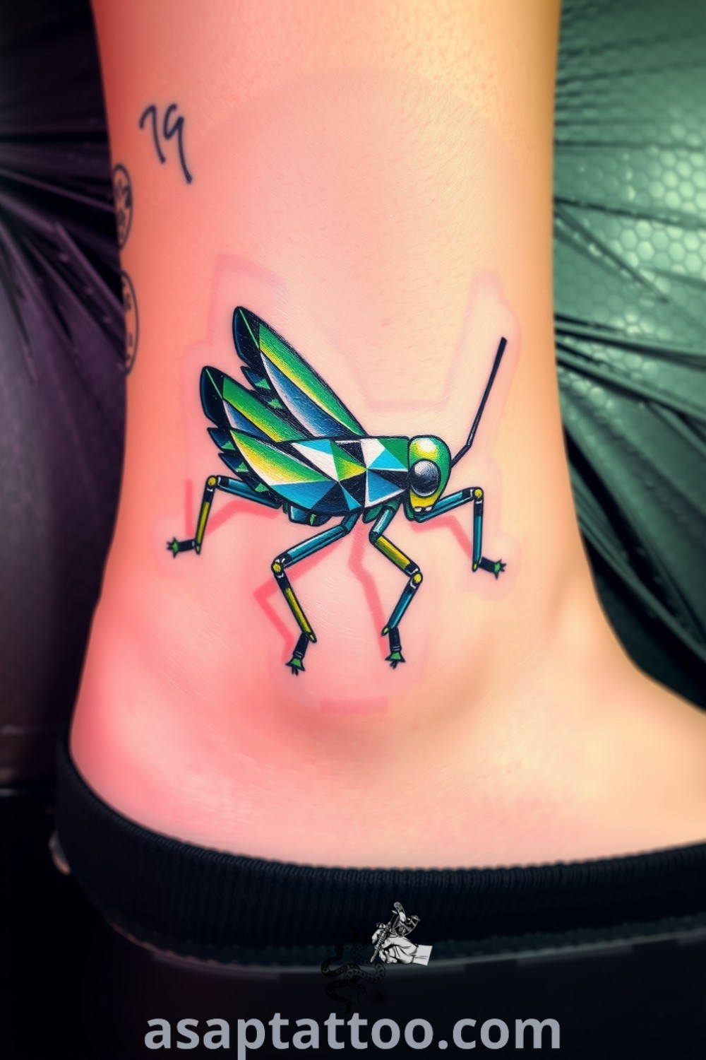 Crystalline grasshopper tattoo on ankle with geometric patterns in vibrant greens and blues, showcasing depth and artistry. A gorgeous tattoo idea to inspire you to get inked. asaptattoo.com