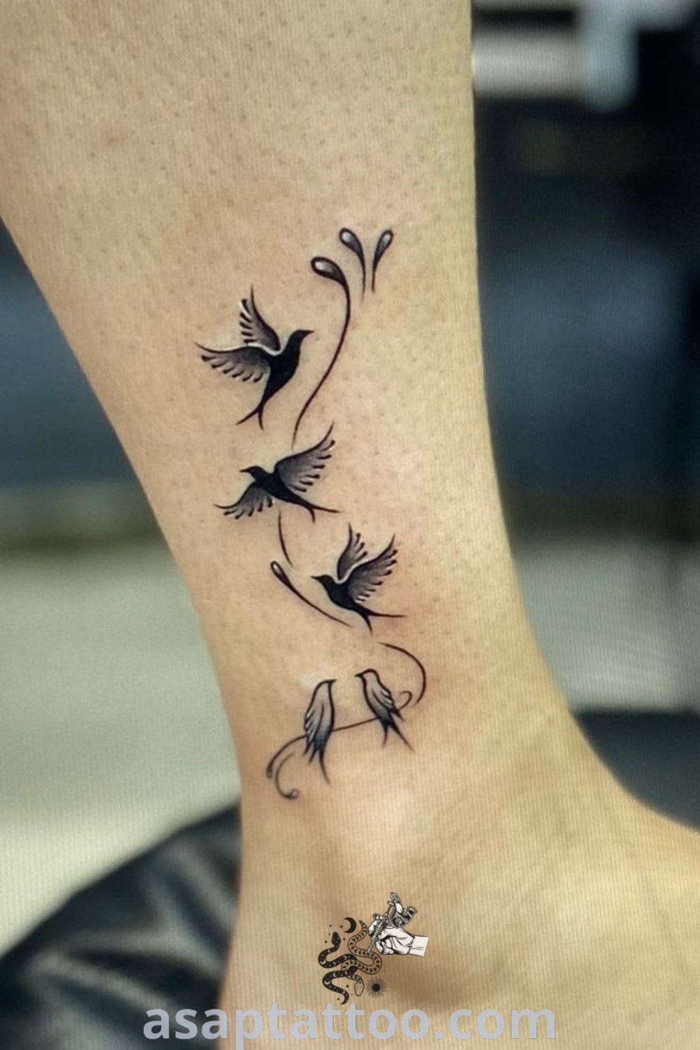 Small bird ankle tattoo on a woman