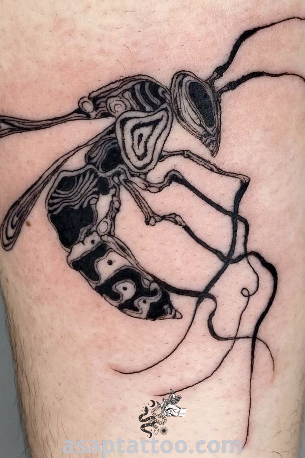 Black and white wasp tattoo on a man