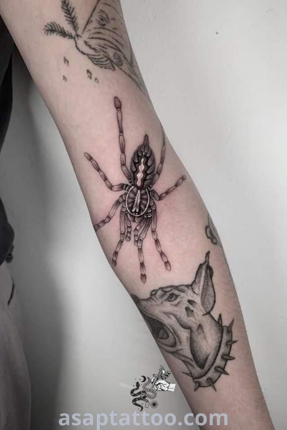A striking tarantula tattoo on an arm, featuring Asian style art and intricate designs, perfect for those seeking sick tattoo ideas. Discover more at asaptattoo.com.