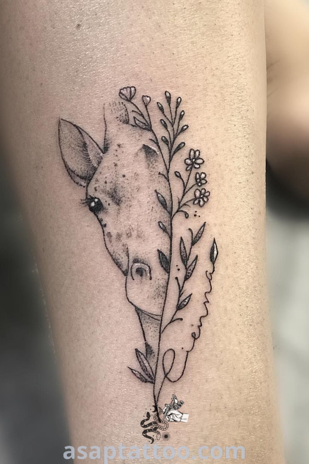 Elegant giraffe flower tattoo showing a side view of a giraffe with flowers on its head. A gorgeous design ideal for animal tattoo lovers and those seeking unique, meaningful ink. Explore more at asaptattoo.com.