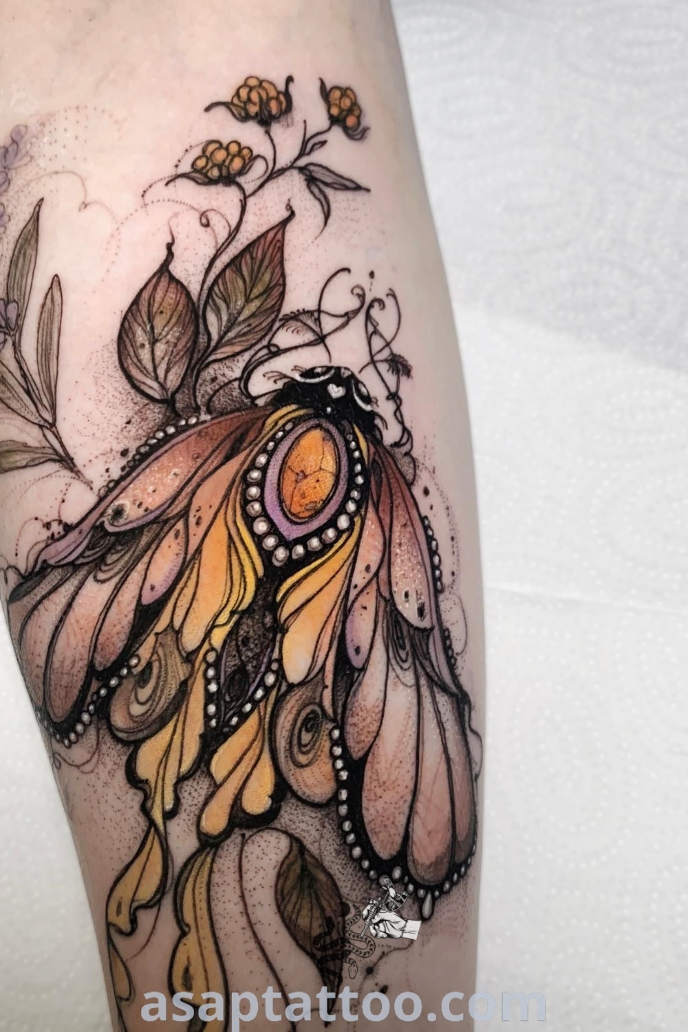 Artistic tattoo design in yellow ink on a woman