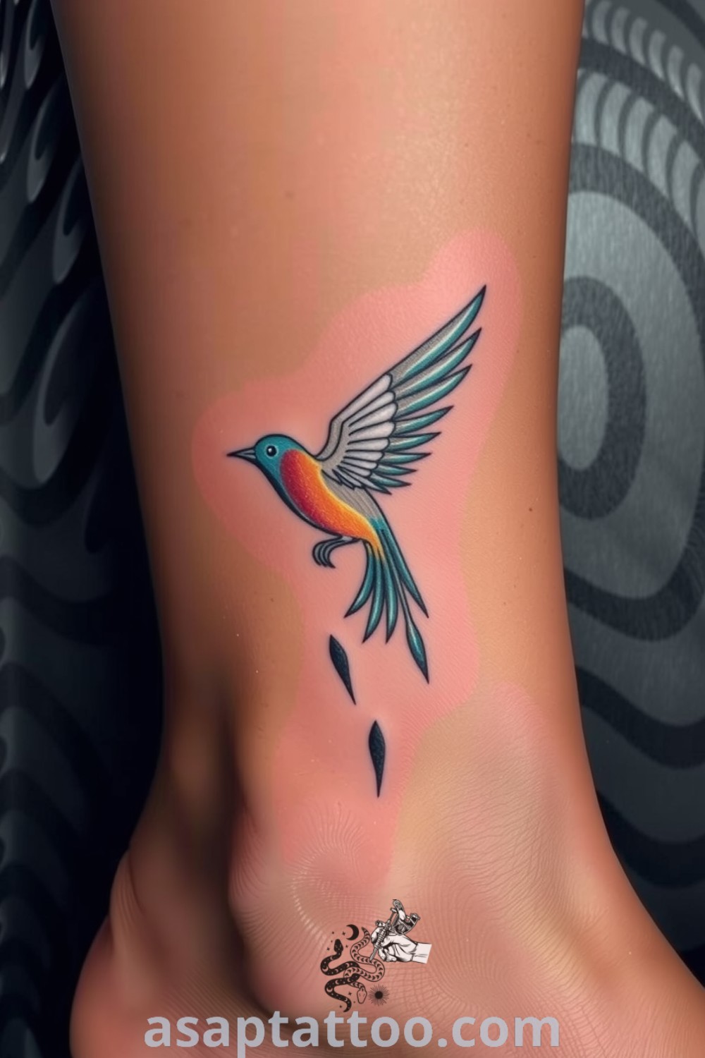 Boho bird tattoo wraps around the ankle with intricate linework and vibrant colors, showcasing artistic beauty and personal significance. A gorgeous tattoo idea you must see to believe. asaptattoo.com