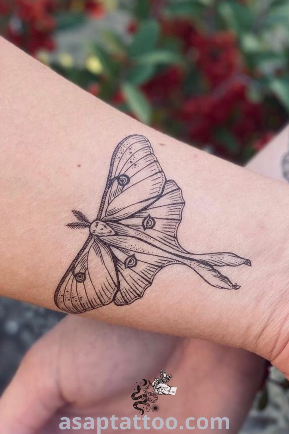 Small butterfly tattoo on the wrist showcasing a beautiful Luna Moth design. Perfect for those seeking artistic tattoos with meaning. Explore more tattoo ideas at asaptattoo.com.