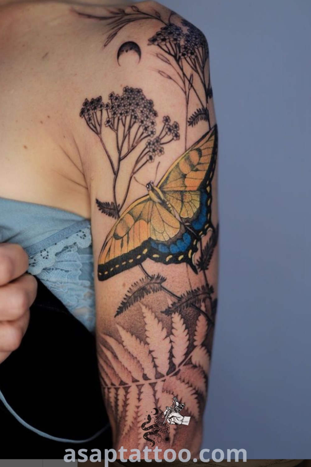 Botanical tattoo sleeve featuring a fern and butterfly design, showcasing elegant floral elements and ancient tattoo artistry. An inspiring piece for body art lovers. Explore more ideas at asaptattoo.com.