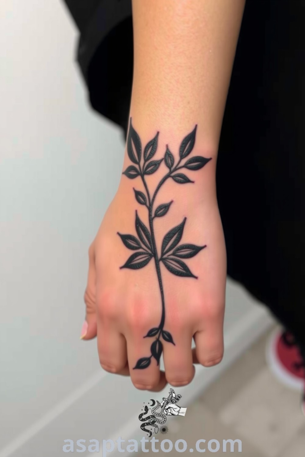 Intricate paper-cut plant tattoo wrapping around the wrist, showcasing sharp edges and layered effects. This gorgeous design highlights the beauty of folk artistry and is one of the best tattoo ideas you have to see to believe. asaptattoo.com