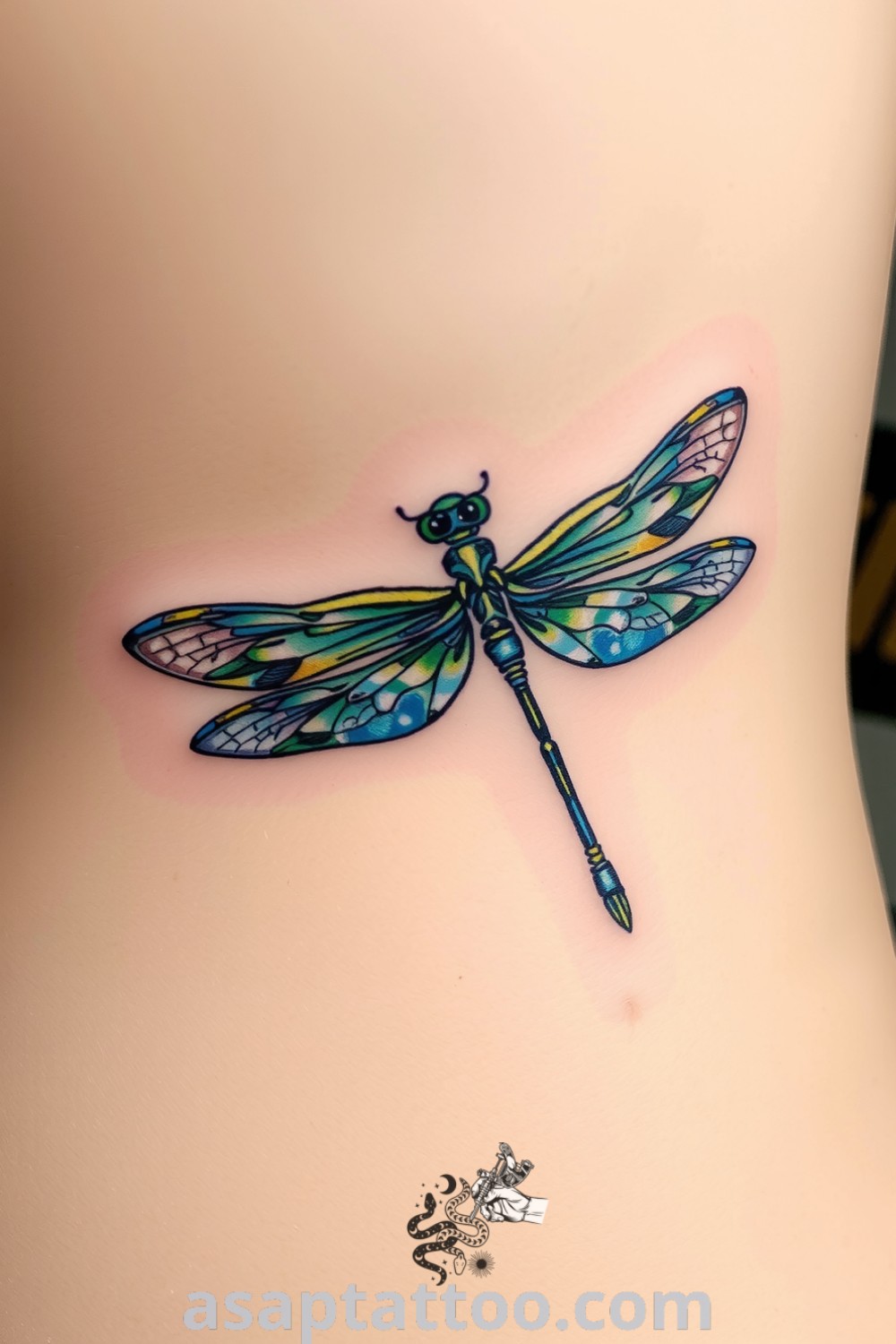 Dragonfly tattoo with intricate linework and vibrant green and blue gradients, showcasing the creature